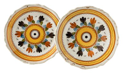 pair of yellow and white plates with flowers and leaves on them