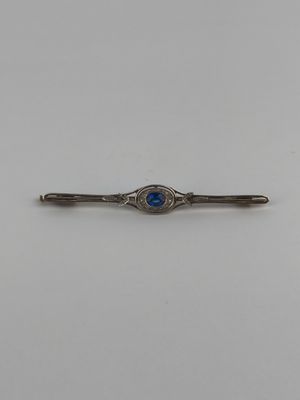 a silver and blue stone tie bar on a white background