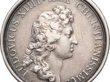une vieille pièce d'argent avec un visage de femme dessus