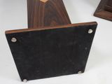 a wooden book holder with a black cover on a white table