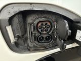 a close up of a car ' s charging station with a plugged in