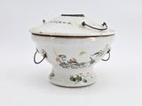 un bol en porcelaine blanche muni d'un couvercle et d'anses