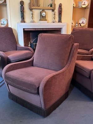 two chairs that are sitting in front of a fire place