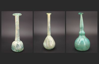 four different views of a green glass vase with a white base