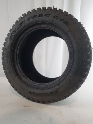 tire on a white surface with a white curtain in the background