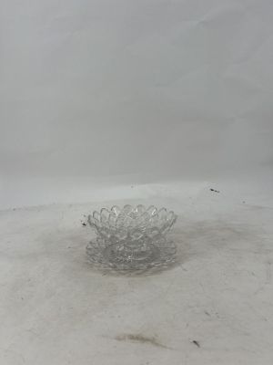 a glass bowl that is sitting on the ground