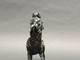 silver statue of a horse with a rider on it ' s back