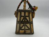 a figurine of a bird sitting on top of a wooden structure