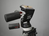 a close up of a tripod with a camera on top of it