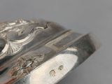 an image of a silver bracelet with a black stone in the center