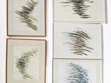 four framed art pieces of different colored brush strokes on a white surface