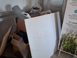 a pile of boxes and a sign in a room