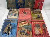 several children ' s books are lined up on a white surface