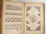 an open book with drawings on it on a table