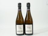 deux bouteilles de vin posées l'une à côté de l'autre sur une surface blanche