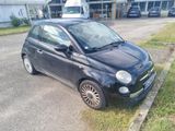 a small black car parked on the side of the road