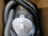 a box with a vacuum and a hose inside of it