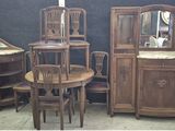 several pieces of furniture including a table, chairs, and a mirror