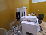 a white printer sitting on top of a desk next to a chair