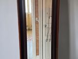 a mirror that is sitting on the floor in front of a wall
