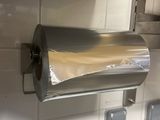 silver paper towel dispenser mounted on a wall in a kitchen