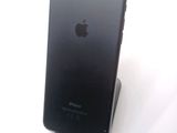 a black iphone that is sitting on top of a stand