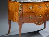 a marble top chest of drawers on display in a room