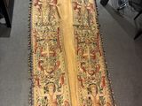 an old rug with a very long design on it