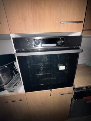 an oven that is built into the wall in the kitchen