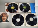 an image of a group of four black vinyl records on a table