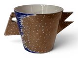 a brown cup with a blue handle on a white background