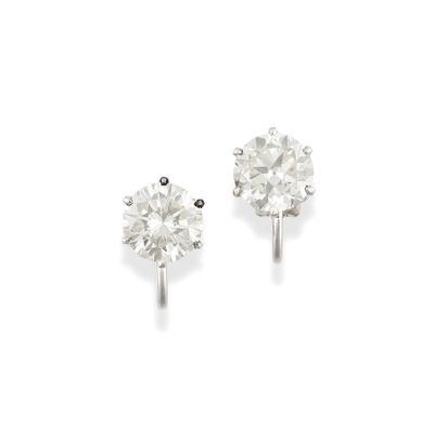 pair of diamond stud earrings on a white background