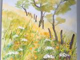 une photo d'un tableau représentant un champ de fleurs et d'arbres
