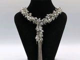a close up of a necklace on a mannequin with a chain