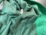an image of a close up of a green jacket with a tag on it