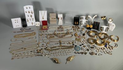 an assortment of gold and silver jewelry including rings, bracelets, rings, and earrings