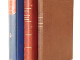 three books are stacked on top of each other on a white surface