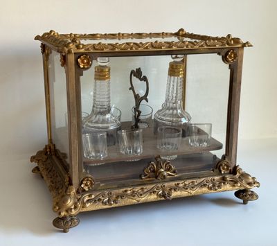 une vitrine contenant trois bouteilles, posée sur une table