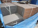 a pile of bricks sitting on top of a blue tarp