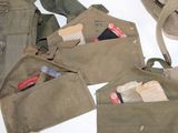 several pieces of military equipment are laid out on a white surface