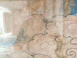 a picture of a woman sitting on a bench in front of a painting
