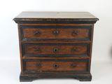a small wooden chest of drawers on a white background