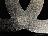 a close up of a metal object on a black surface