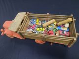 a toy truck with a lot of toy cars in it