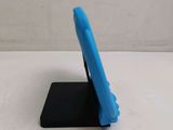 a small blue cell phone sitting on a black stand