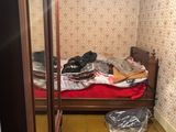 an image of a bedroom with a bed and a closet