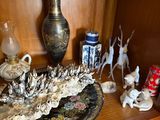 a wooden shelf with a vase, vase, and other items on it