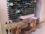 a wooden workbench with a bunch of tools on it