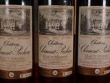 three bottles of wine that are sitting on a table