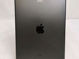 an apple ipad is sitting on a stand on a white surface